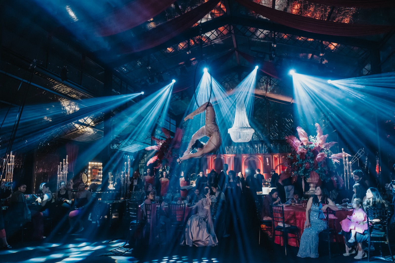 Aerialist performing above guests at a wedding event