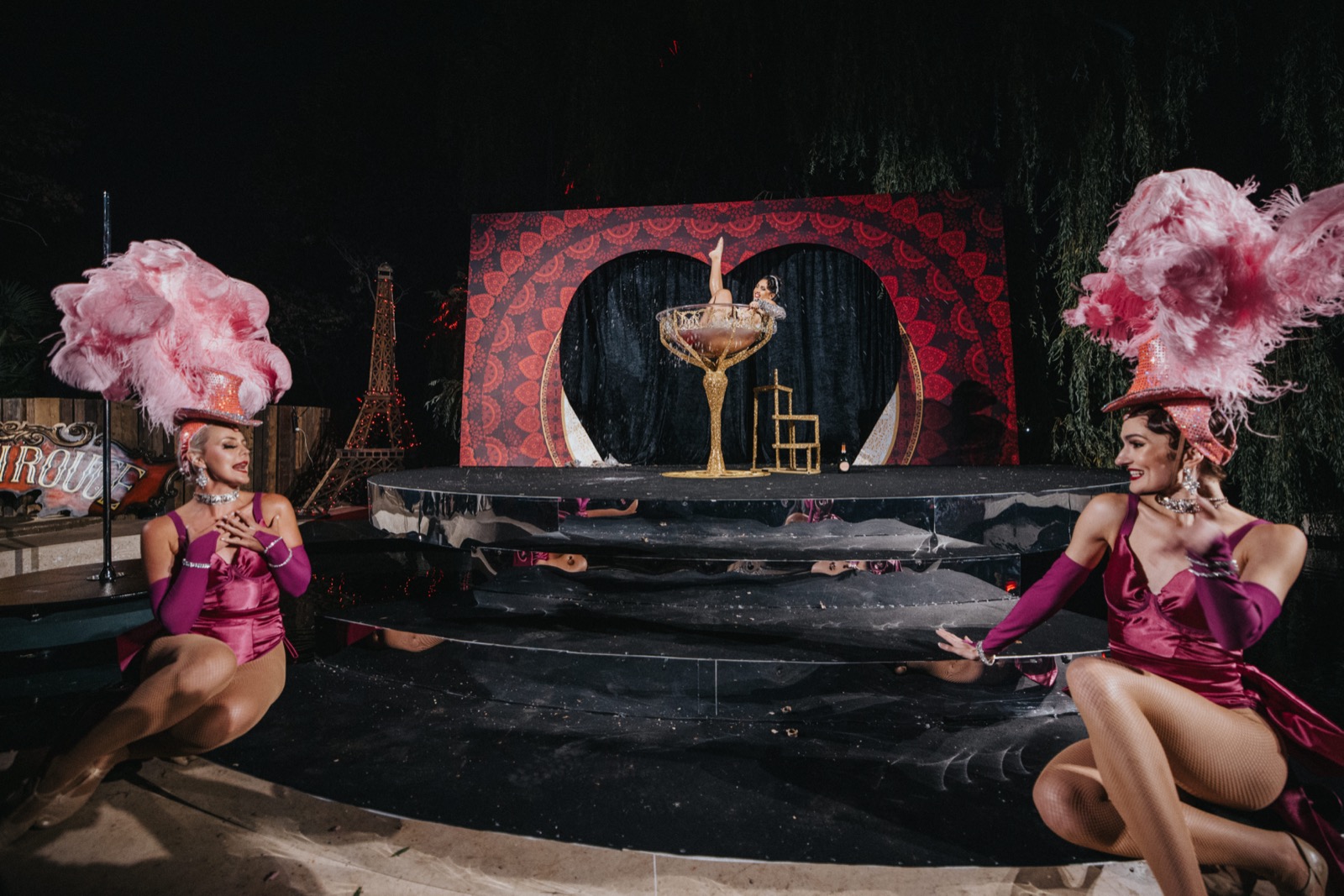 A burlesque martini glass performance during a wedding celebration show