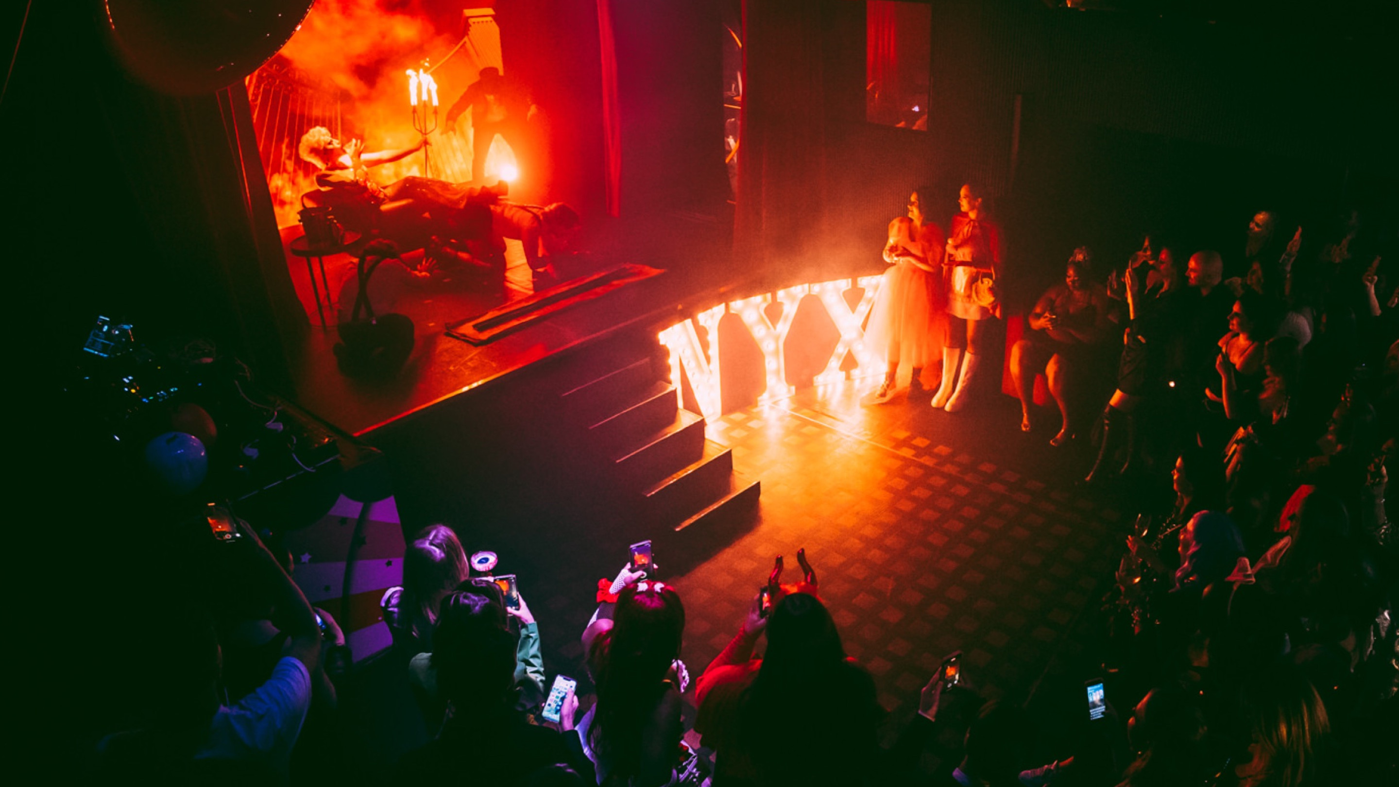 A performer performing a dramatic fire act at a brand event