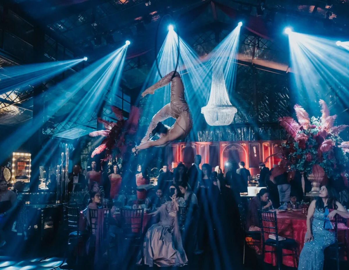 Aerialist performing above guests at a wedding event
